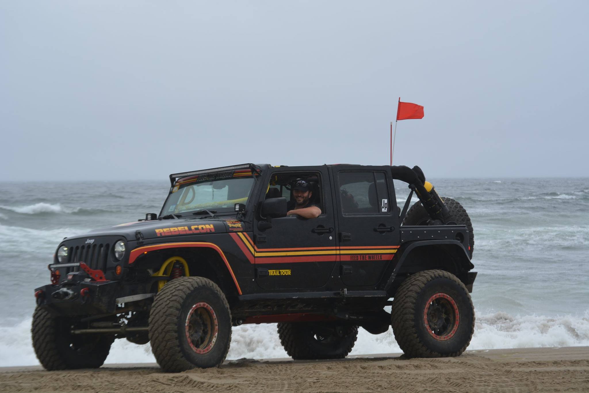 Justin behind the wheel of his Feed the Wheels Jeep on the Oregon coast